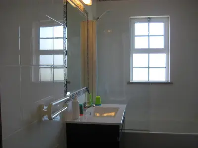 a bathroom with a sink and a mirror and a window at GUADALUPE 3 in Luz