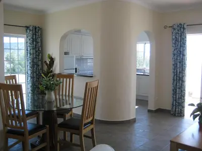 a kitchen and dining room with a table and chairs at GUADALUPE 3 in Luz