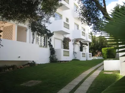 a large white building with a grass yard at GUADALUPE 3 in Luz