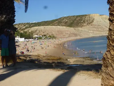 a group of people on a beach near the water at GUADALUPE 3 in Luz