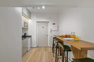 a kitchen with white walls and a wooden counter top at Navio Azul Apartment in Funchal