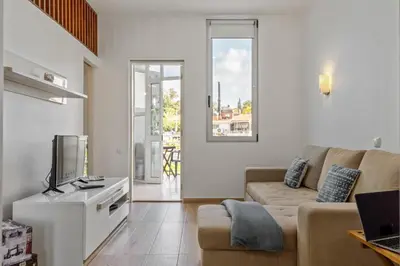 a living room with a couch and a tv at Navio Azul Apartment in Funchal