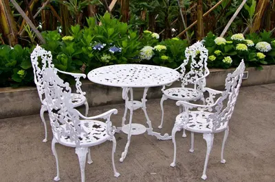 a table and four chairs and a table with flowers at Quinta Tallinus in Funchal
