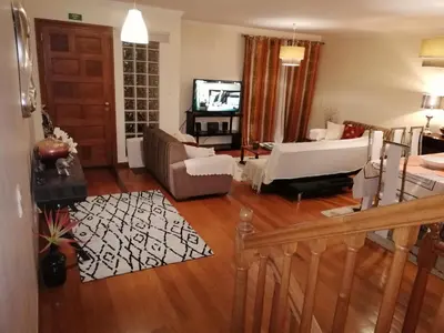 a living room with a couch and a tv at Imaculado Village in Funchal