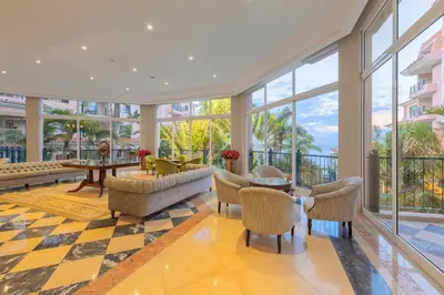 a living room with furniture and large windows at Pestana Royal All Inclusive Ocean & Spa Resort in Funchal