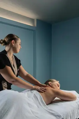 a woman giving a man a massage on a bed at Pestana Royal All Inclusive Ocean & Spa Resort in Funchal