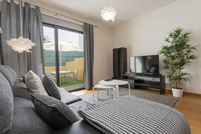 a living room with a couch and a tv at Pena I by An Island Apart in Funchal