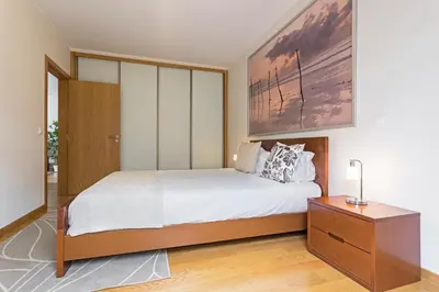 a bedroom with a large bed and a wooden dresser at Pena I by An Island Apart in Funchal