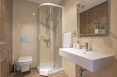 a bathroom with a sink and a shower and a toilet at Pena I by An Island Apart in Funchal
