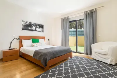 a bedroom with a bed and a chair at Pena I by An Island Apart in Funchal