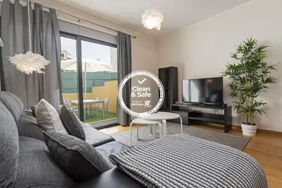 a living room with a couch and a tv at Pena I by An Island Apart in Funchal