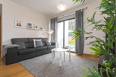 a living room with a black couch and a table at Pena I by An Island Apart in Funchal