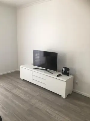 a white entertainment center with a flat screen tv on it at Feel Funchal in Funchal