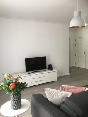 a living room with a tv and a couch at Feel Funchal in Funchal