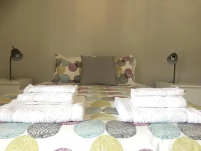 a bed with several pillows on top of it at Feel Funchal in Funchal