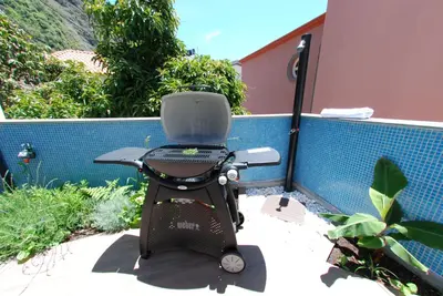 a chair sitting on a patio next to a fence at Serenity in Jardim do Mar