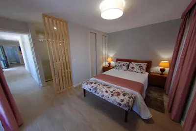 a bedroom with a bed and a sliding glass door at Serenity in Jardim do Mar