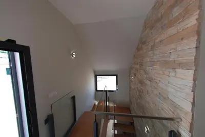 a staircase with a stone wall in a room at Serenity in Jardim do Mar