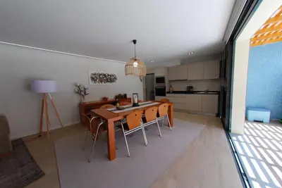a kitchen and dining room with a table and chairs at Serenity in Jardim do Mar