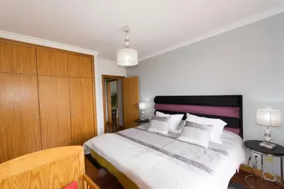 a bedroom with a large white bed with white pillows at Palace II in Funchal