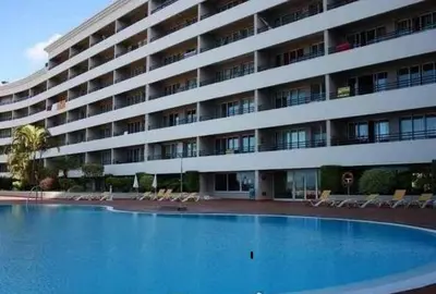a large building with a large swimming pool in front of it at Palace II in Funchal