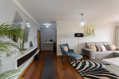 a living room with a couch and a chair at Palace II in Funchal
