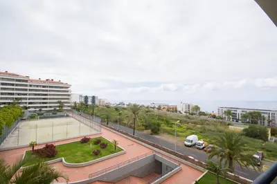 a view of a city street with a tennis court at Palace II in Funchal