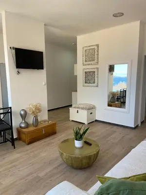 a living room with a couch and a table at Feeling Like Home Machico in Machico