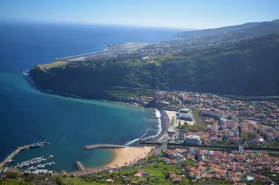 an aerial view of a beach and the ocean at Feeling Like Home Machico in Machico