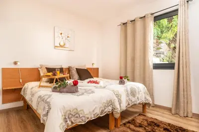 a bedroom with a bed and a window at Casa da Tenda in Arco da Calheta