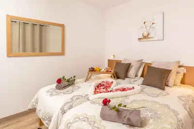 a bedroom with a bed with flowers on it at Casa da Tenda in Arco da Calheta
