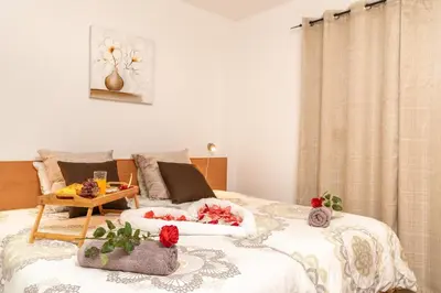 a bedroom with a bed with flowers on it at Casa da Tenda in Arco da Calheta