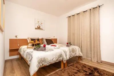 a bedroom with a bed and a table with fruits on it at Casa da Tenda in Arco da Calheta