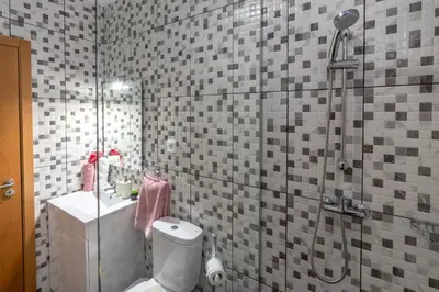 a bathroom with a shower and a toilet and a sink at Casa da Tenda in Arco da Calheta
