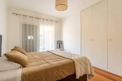 a bedroom with a bed and a large window at Virtudes Ocean view with pool by Holiday Rental Madeira in Funchal