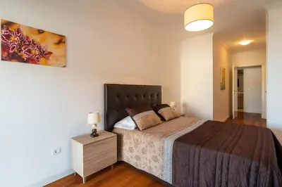 a bedroom with a large bed in a room at Virtudes Ocean view with pool by Holiday Rental Madeira in Funchal