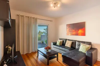 a living room with a couch and a table at Virtudes Ocean view with pool by Holiday Rental Madeira in Funchal