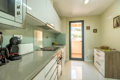 a kitchen with white counters and a counter top at Funchal SilverWood Apartment - by LovelyStay in Funchal