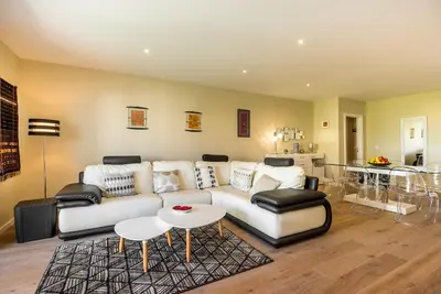 a living room with a couch and a table at Funchal SilverWood Apartment - by LovelyStay in Funchal
