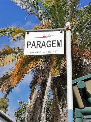 a street sign in front of a palm tree at FLH Garajau Balcony with Pool in Caniço