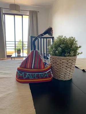 a purse sitting on a table next to a potted plant at FLH Garajau Balcony with Pool in Caniço