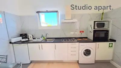 a kitchen with a sink and a washing machine at Discovery Apartment in Santana