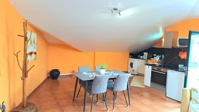 a kitchen with a table and chairs in a room at Discovery Apartment in Santana