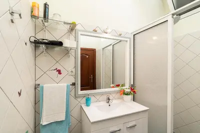a bathroom with a sink and a mirror at Casa das Camélias in Arco da Calheta