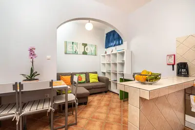 a living room with a couch and a table at Casa das Camélias in Arco da Calheta