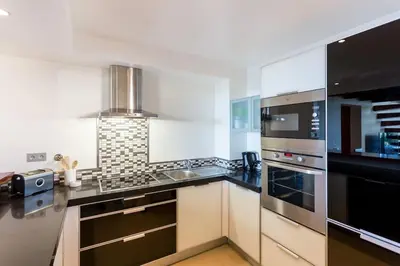 a kitchen with a stainless steel stove top oven at Mar da Luz in Luz