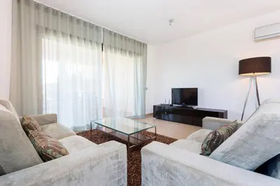 a living room with two couches and a glass coffee table at Mar da Luz in Luz