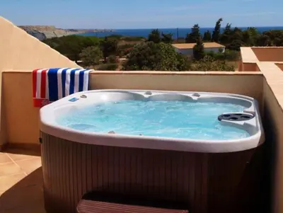 a hot tub on a balcony with a view at Mar da Luz in Luz