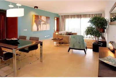 a living room with a table and a couch at Mar da Luz in Luz