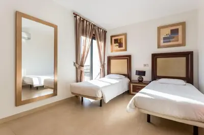 a bedroom with two beds and a large mirror at Mar da Luz in Luz